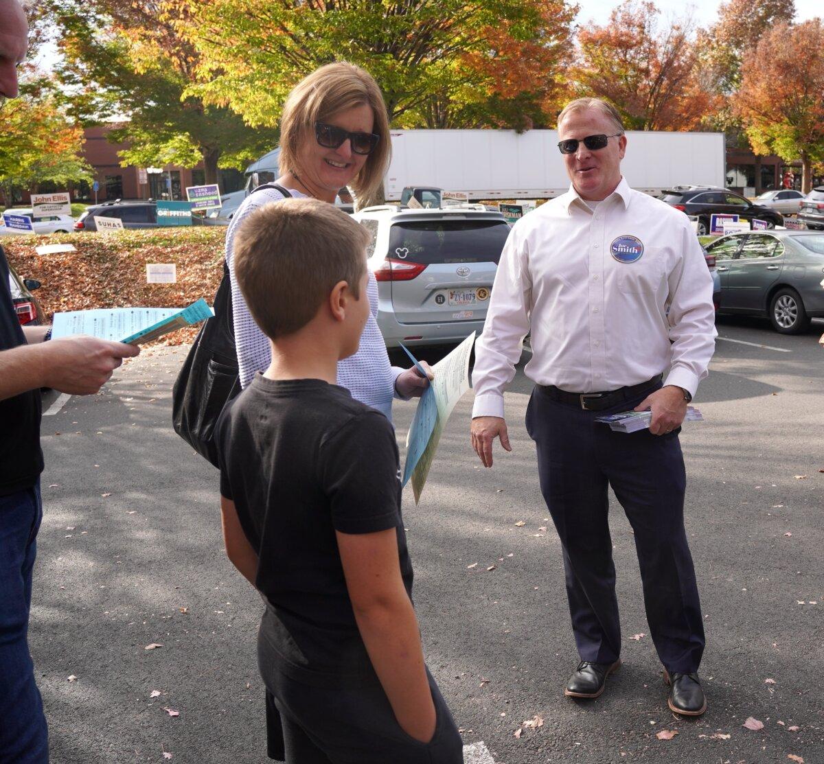 Loudoun County Little River District School Board candidate Joe Smith (R) speaks to voters outside the Loudoun County Office of Elections in Leesburg, Va., on Nov. 4, 2023. (Terri Wu/The Epoch Times)