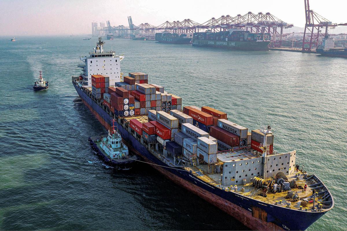 A cargo ship loaded with containers makes its way at a port in Qingdao in China's eastern Shandong province on January 14, 2020. China's trade surplus with the United States narrowed last year as the world's two biggest economies exchanged punitive tariffs in a bruising trade war, official data showed on January 14, on the eve of a deal to ease tensions. (Photo by AFP) (Photo by STR/AFP via Getty Images)