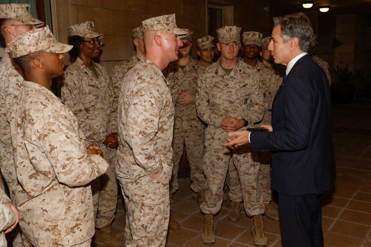  U.S. Secretary of State Antony Blinken exchanges challenge coins with the U.S. Marine Corps embassy security guard detachment in Baghdad, Iraq, on Nov. 5, 2023. (Jonathan Ernst/Pool/AFP via Getty Images)