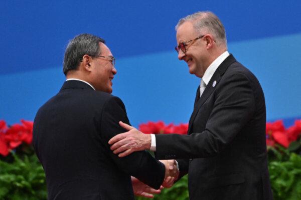 China's Premier Li Qiang (L) and Australia's Prime Minister Anthony Albanese shake hands during the opening ceremony of the sixth China International Import Expo (CIIE) in Shanghai on Nov. 5, 2023. (Hector Retamal/AFP via Getty Images)