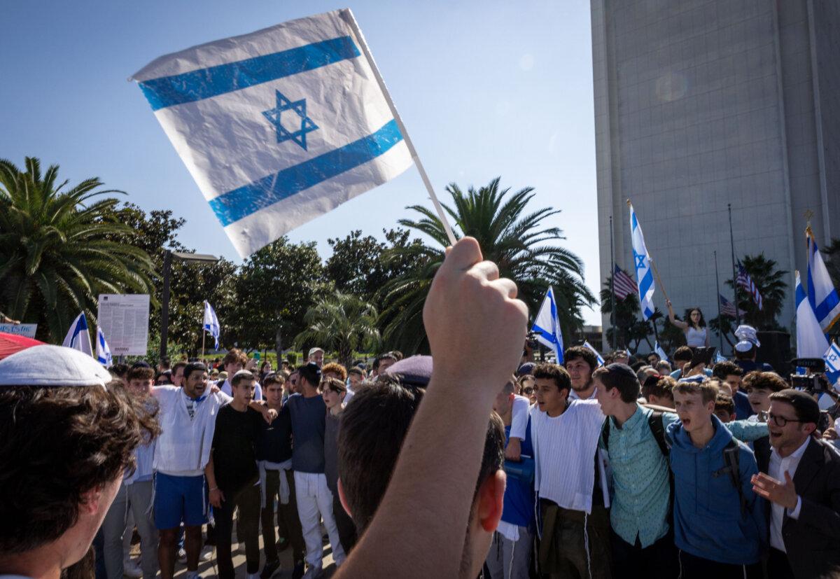 A demonstrator waves an Israeli flag during a rally in solidarity with Israel in Los Angeles Oct. 10, 2023. (Ethan Swope/Getty Images)