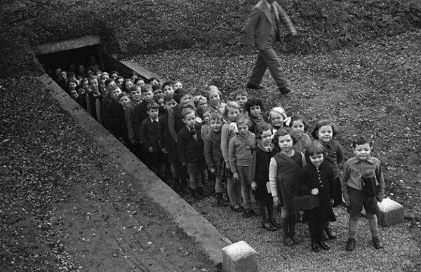 Children outside air raid shelter in Gresford, Wales, 1939. (Geoff Charles/CC0)