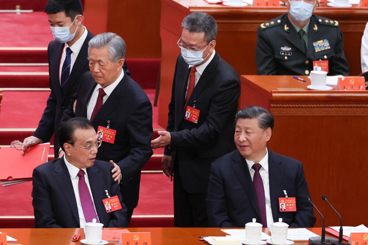 The then-Chinese premier Li Keqiang, former CCP leader Hu Jintao, and current CCP leader Xi Jinping attend the closing ceremony of the 20th National Congress of the Communist Party of China (CPC) at the Great Hall of the People on Oct. 22, 2022 in Beijing, China. (Lintao Zhang/Getty Images)