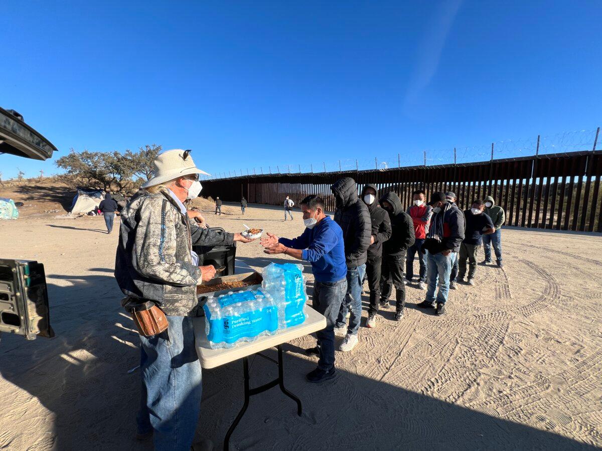 Volunteers feed migrants a hot meal in Jacumba, Calif., on Oct. 31, 2023. (Brad Jones/The Epoch Times)
