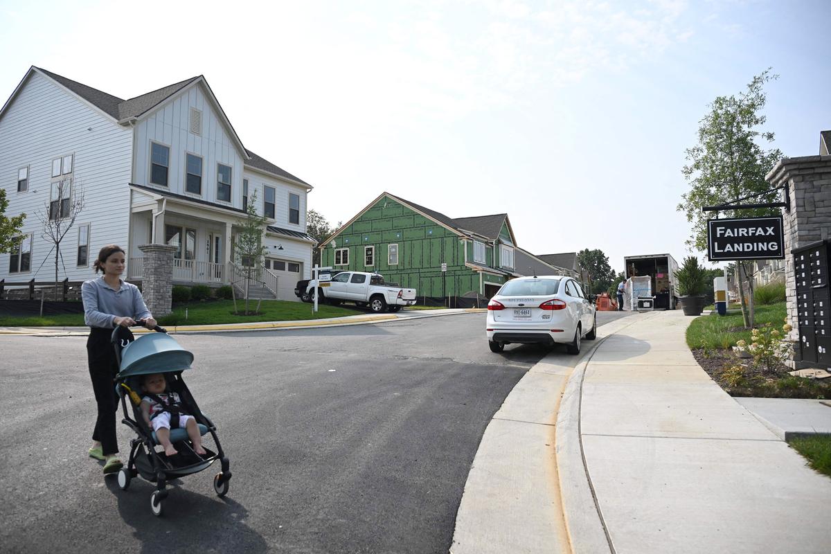 A woman pushes a stroller in a new housing development in Fairfax, Va., on Aug. 22, 2023. (ANDREW CABALLERO-REYNOLDS/AFP via Getty Images)
