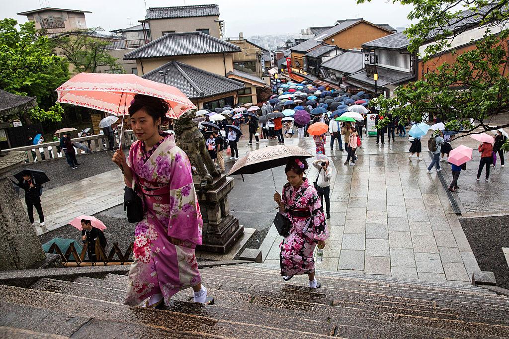 Tourists dressed in yukatas, a light, unlined, summer kimono made of cotton instead of the traditional silk, climb steps to visit a temple on April 27, 2016, in Kyoto, Japan. (Carl Court/Getty Images)