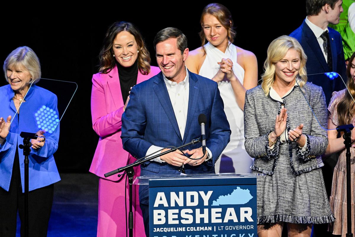 Kentucky incumbent Democratic Gov. Andy Beshear is joined by his wife, Britainy Beshear (R), Kentucky Lt. Gov. Jacqueline Coleman (center L), and his family as he delivers his victory speech at an election night event at Old Forrester's Paristown Hall in Louisville, Ky., on Nov. 7, 2023. Mr. Beshear defeated Republican challenger Kentucky Attorney General Daniel Cameron and will serve a second term as governor. (Stephen Cohen/Getty Images)
