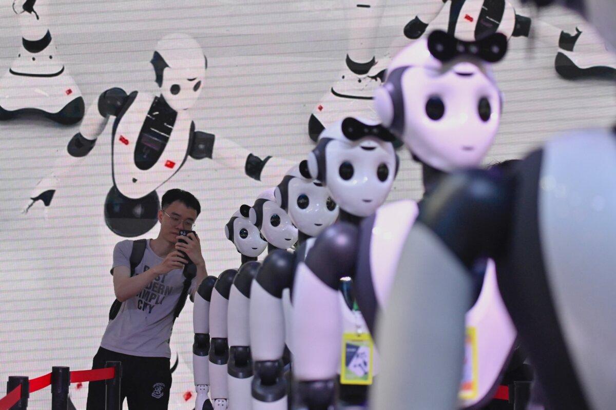 A man takes a picture of robots during the World Artificial Intelligence Conference in Shanghai, on July 7, 2023. (Wang Zhao/AFP via Getty Images)