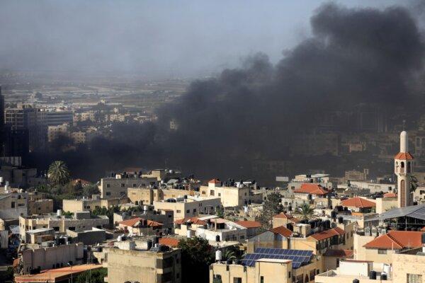 Black smoke rises from the Jenin Palestinian refugee camp during clashes with the Israeli military in the occupied West Bank on Nov. 9, 2023. (Zain Jaafar/AFP via Getty Images)