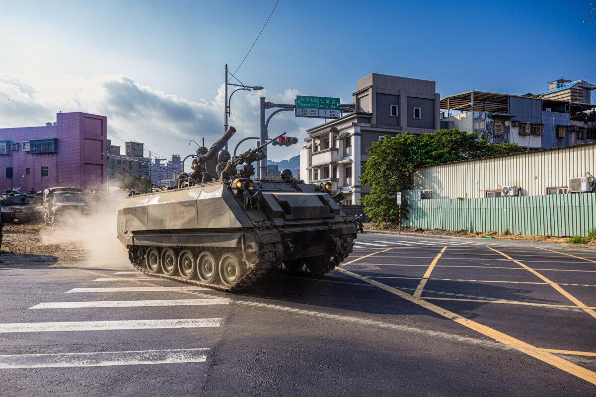 Taiwanese military personnel drive a CM-25 armored vehicle across the street during the Han Kuang military exercise, which simulates China’s People’s Liberation Army invading the island in New Taipei City, Taiwan, on July 27, 2022. (Annabelle Chih/Getty Images)
