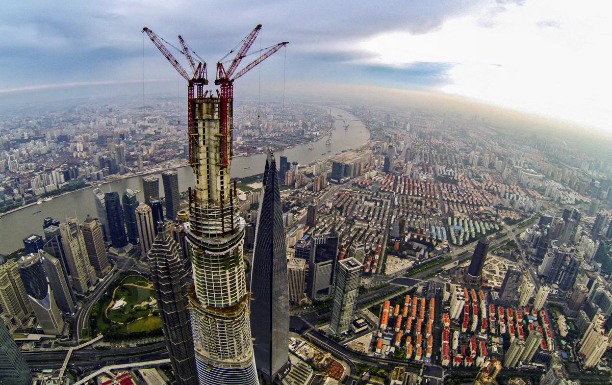 An aerial view of the under-construction Shanghai Tower (C) flanked by the Jin Mao Tower (L) and the Shanghai World Financial Center (R), in Shanghai, on Aug. 4, 2013. (STR/AFP via Getty Images)