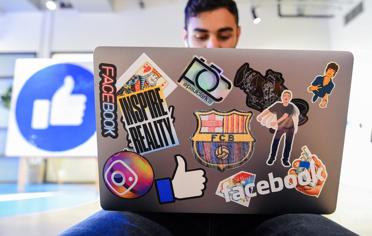  Facebook employee Mohamed Almari works from his laptop decorated in various Facebook stickers at the company's corporate headquarters campus in Menlo Park, Calif., on Oct. 23, 2019. (JOSH EDELSON/AFP via Getty Images)