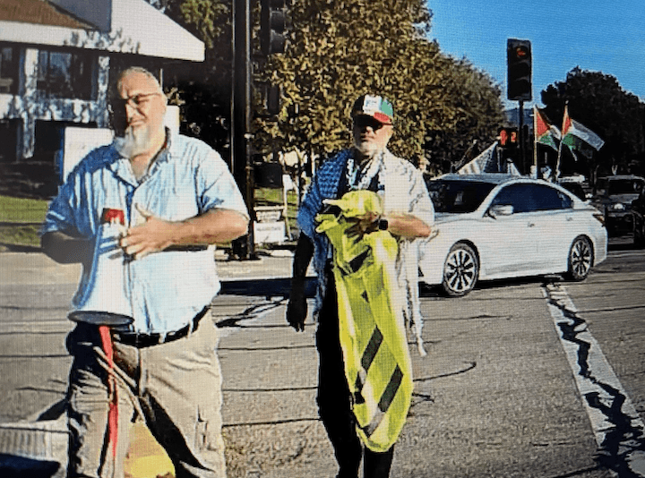 Loay Alnaji (L) the alleged suspect in the death of 69-year-old Paul Kessler, a Jewish man, carries a megaphone in Thousand Oaks, Calif., on Nov. 5, 2023. (Courtesy Of Jonathan Oswaks)