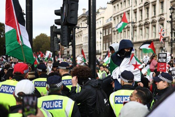 Police officers and protesters in Parliament Square during the 'March For Palestine' in London on Oct. 28, 2023 (Henry Nicholls/AFP via Getty Images)