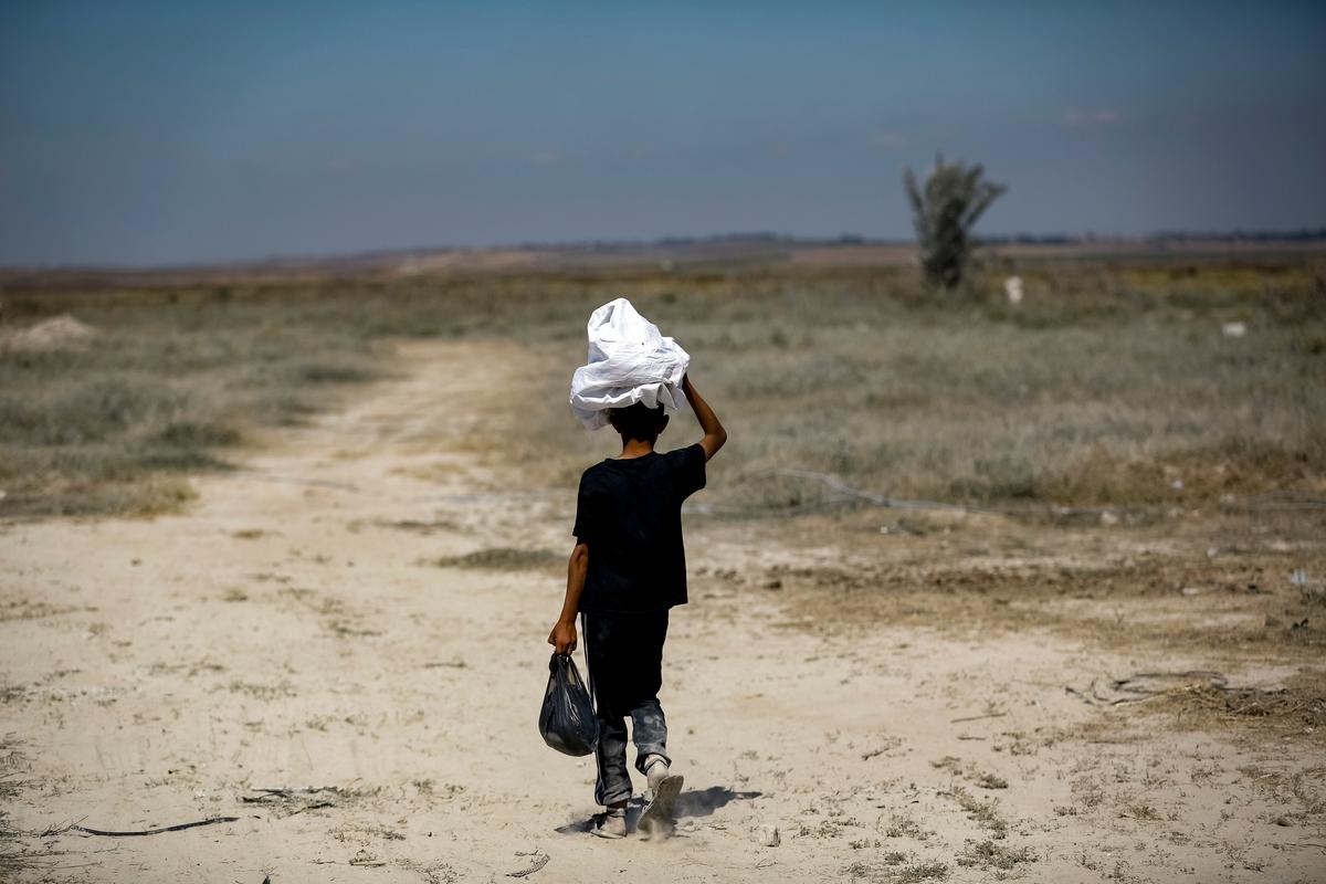  A Palestinian boy walks in the Gaza Strip near the Nahal Oz border crossing with Israel on May 15, 2015. (MOHAMMED ABED/AFP via Getty Images)