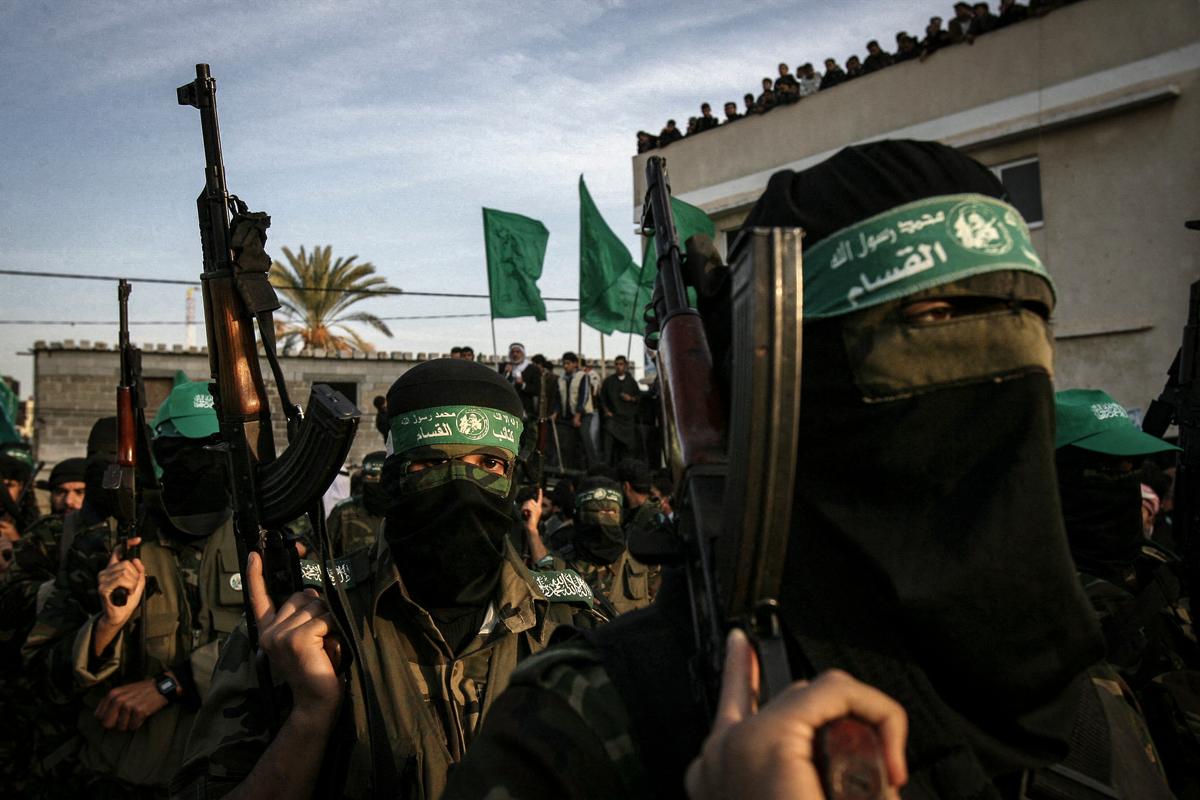  Palestinian masked terrorists from the ruling Hamas party march at a rally marking the 19th anniversary of Hamas in Khan Yunis in the Gaza Strip, on Dec. 14, 2006. (SAID KHATIB/AFP via Getty Images)