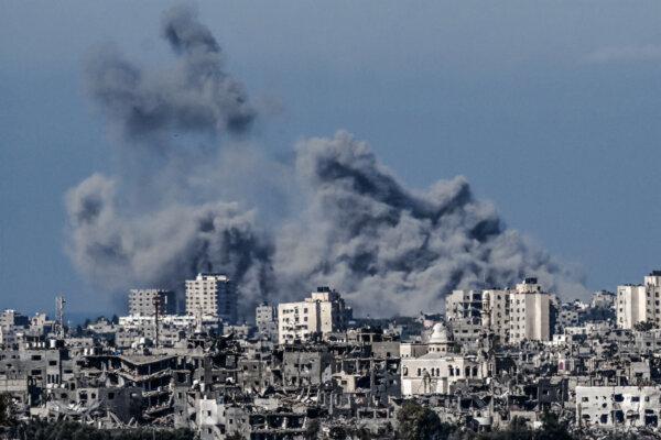 A picture taken from the Israeli side of the border with the Gaza Strip shows smoke rising behind destroyed buildings in the northwestern part of the Palestinian enclave during an Israeli bombing amid the ongoing battles between Israel and Hamas. on Oct. 21, 2023. (Aris Messinis/AFP via Getty Images)