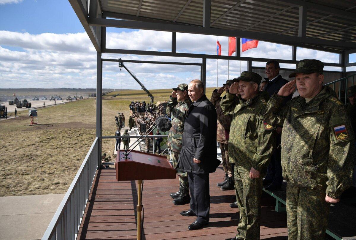 Russian President Vladimir Putin (2nd L), Chinese Defense Minister Wei Fenghe (L), Russian Defense Minister Sergei Shoigu (3rd R), and Chief of the General Staff of the Russian Armed Forces Valery Gerasimov (R) watch the parade of the participants of the Vostok-2018 (East-2018) military drills at Tsugol training ground, not far from the Chinese and Mongolian border in Siberia, on Sept. 13, 2018. (Alexey Nikolsky/AFP via Getty Images)