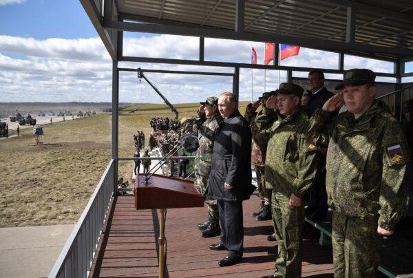 Russian President Vladimir Putin (2nd L), Chinese Defense Minister Wei Fenghe (L), Russian Defence Minister Sergei Shoigu (3rd R), and Chief of the General Staff of the Russian Armed Forces Valery Gerasimov (R) watch the parade of the participants of the Vostok-2018 (East-2018) military drills at Tsugol training ground not far from the Chinese and Mongolian border in Siberia on Sept. 13, 2018. (Alexey Nikolsky/AFP via Getty Images)