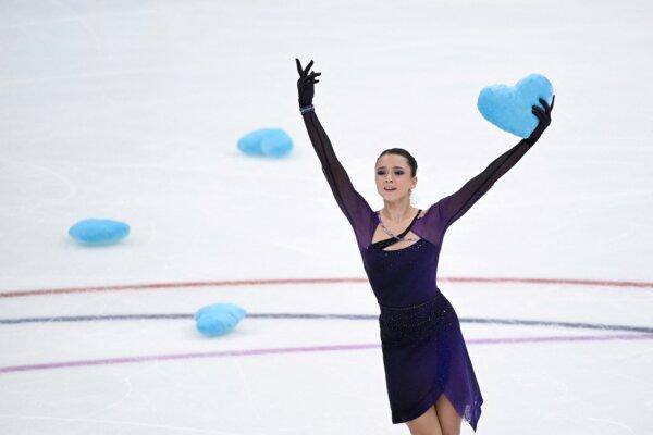 Russia's figure skater Kamila Valieva brandishes a blue heart pillow as she reacts after competing in the women's short program during the Russian Grand Prix of Figure Skating at the Megasport Arena in Moscow on Oct. 22, 2022. (Natalia Kolesnikova/AFPvia Getty Images)