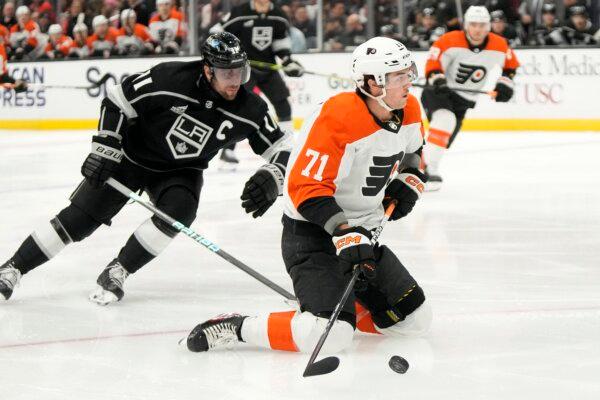 Philadelphia Flyers right wing Tyson Foerster (R) tries to shoot the puck from his knees while under pressure from Los Angeles Kings center Anze Kopitar during the first period of an NHL hockey game in Los Angeles on Nov. 11, 2023. (Mark J. Terrill/AP Photo)