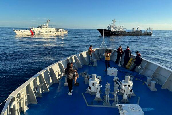 Chinese coast guard and suspected Chinese militia ships block the Philippine Coast Guard ship BRP Cabra as they approach Second Thomas Shoal, also known as Ayungin Shoal, during a resupply mission at the disputed South China Sea, on Nov. 10, 2023. (Joeal Calupitan/AP Photo)