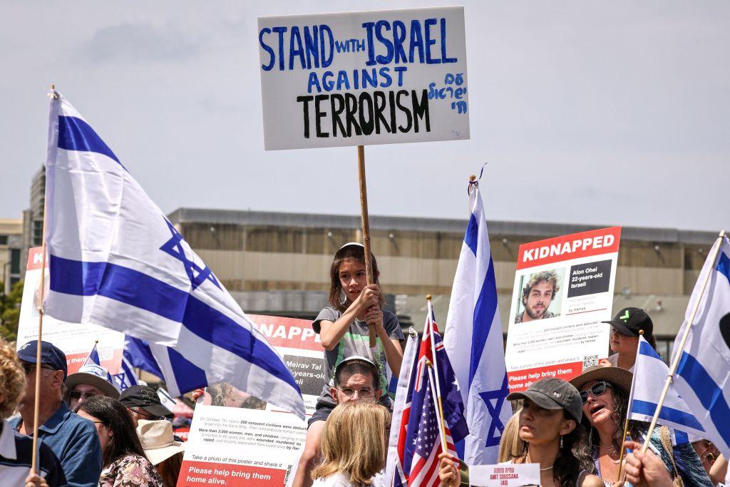 Members of the Australian Jewish community hold placards and flags during a rally in Sydney on Nov. 12, 2023. (David Gray/AFP via Getty Images)