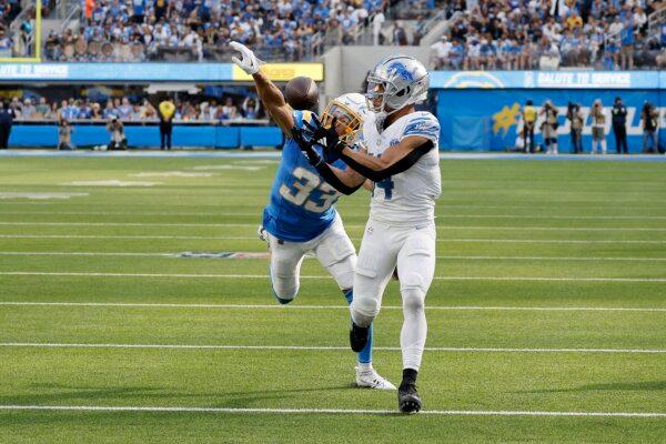 Deane Leonard (33) of the Los Angeles Chargers blocks a pass intended for Anaheim Hills, Calif., native Amon-Ra St. Brown (14), of the Detroit Lions during the first half in Los Angeles on Nov. 12, 2023. (Kevork Djansezian/Getty Images)