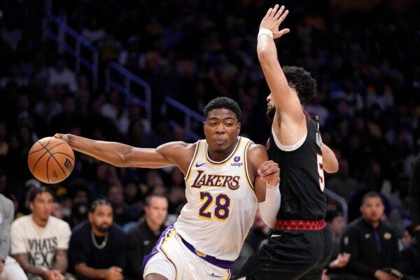 Los Angeles Lakers forward Rui Hachimura (L), drives past Portland Trail Blazers guard Skylar Mays during the first half of an NBA basketball game in Los Angeles on Nov. 12, 2023. (Mark J. Terrill/AP Photo)