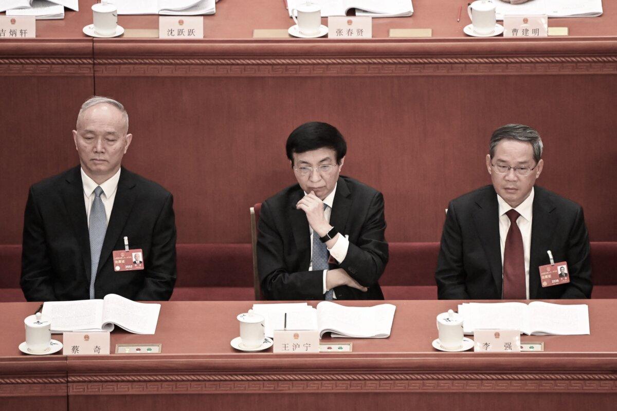 (L-R) Politburo Standing Committee members Cai Qi, Wang Huning and Li Qiang attend the second plenary session of the National People's Congress (NPC) at the Great Hall of the People in Beijing on March 7, 2023. (GREG BAKER/AFP via Getty Images)