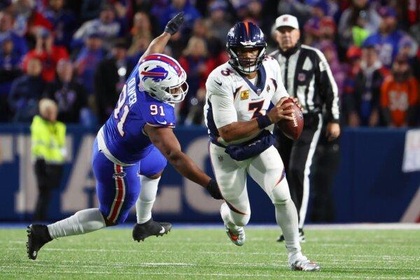 Russell Wilson (3) of the Denver Broncos carries the ball against the Buffalo Bills during the first half of the game at Highmark Stadium in Orchard Park, N.Y. on Nov. 13, 2023. (Timothy T Ludwig/Getty Images)