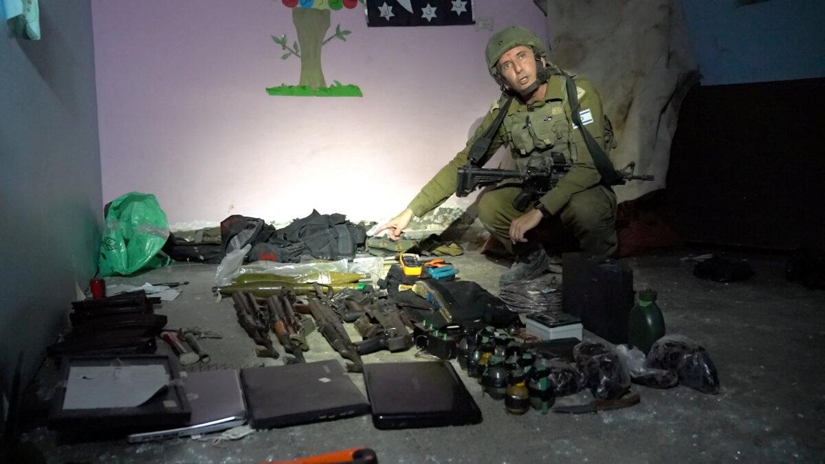 Israeli military spokesperson Rear Admiral Daniel Hagari shows what he says are weapons stored by Hamas terrorists in the basement of Rantissi Hospital, a pediatric hospital with a specialty in treating cancer patients, at a location given as Gaza, in this still image taken from video released on Nov. 13, 2023. (Israel Defense Forces/Handout via Reuters)