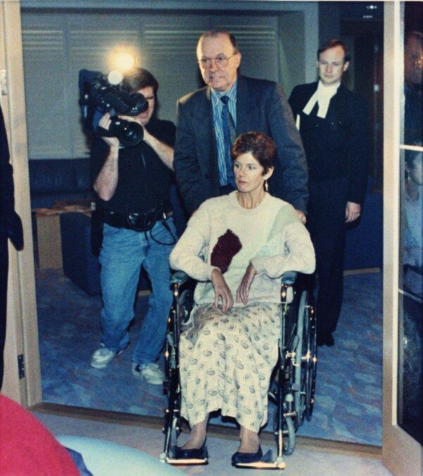 Sue Rodriguez, who suffered from amyotrophic lateral sclerosis, is pushed in a wheelchair to a room for a news conference in Vancouver on Dec. 3, 1992. (CP PHOTO/Chuck Stoody)