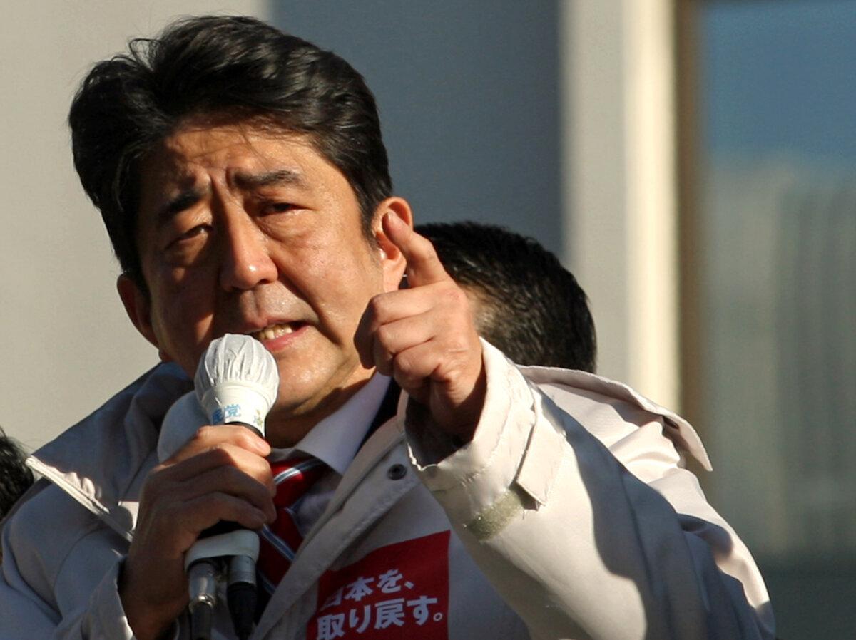 Former Prime Minister and leader of Japan's main opposition Liberal Democratic Party (LDP) Shinzo Abe gives a speech from the roof of a campaign car during his party election campaign in Osaka, Japan, on Dec. 13, 2012. (Buddhika Weerasinghe/Getty Images)