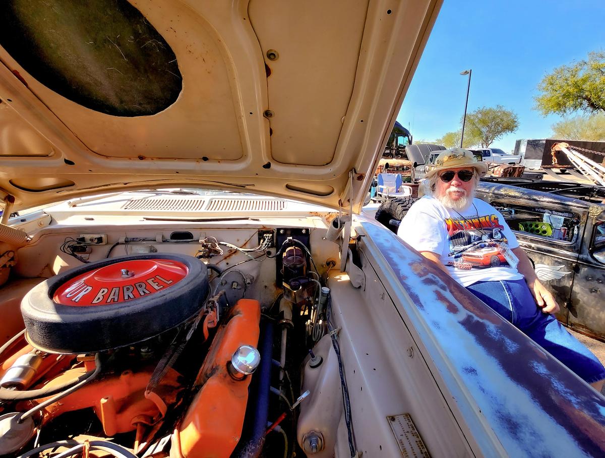 Bob Hughes sits beside his 1963 Dodge 330 during a car show in Casa Grande, Ariz., on Nov. 4, 2023. (Allan Stein/The Epoch Times)