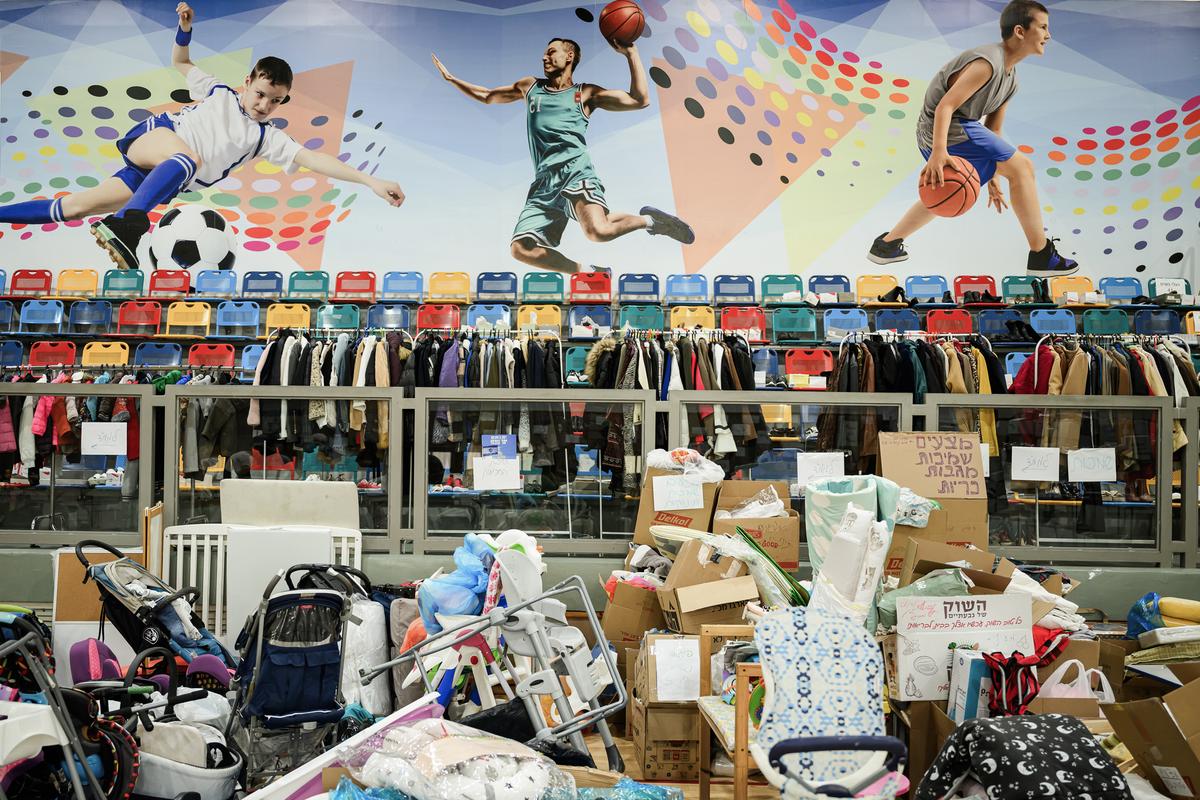 Volunteers sort donated clothes for those forced to flee their homes following the Hamas attack, at a sports gym in Ramat Gan, Israel, on Oct. 24, 2023. (Leon Neal/Getty Images)