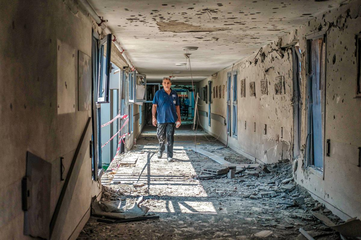A hospital worker passes a destroyed area of Barzilai Hospital after it was hit by a missile, in Ashkelon, Israel, on Oct. 11, 2023. (Tamar Shemesh/Middle East Images/AFP via Getty Images)