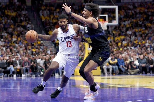 Paul George (13) of the Los Angeles Clippers drives against Zeke Nnaji (22) of the Denver Nuggets in the fourth quarter in Denver on Nov. 14, 2023. (Matthew Stockman/Getty Images)