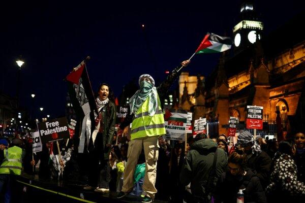 Protesters hold placards and flags as they chant slogans during a rally in support of Palestinians, outside of the Houses of Parliament in central London on Nov. 15, 2023. (Henry Nicholls/AFP via Getty Images)