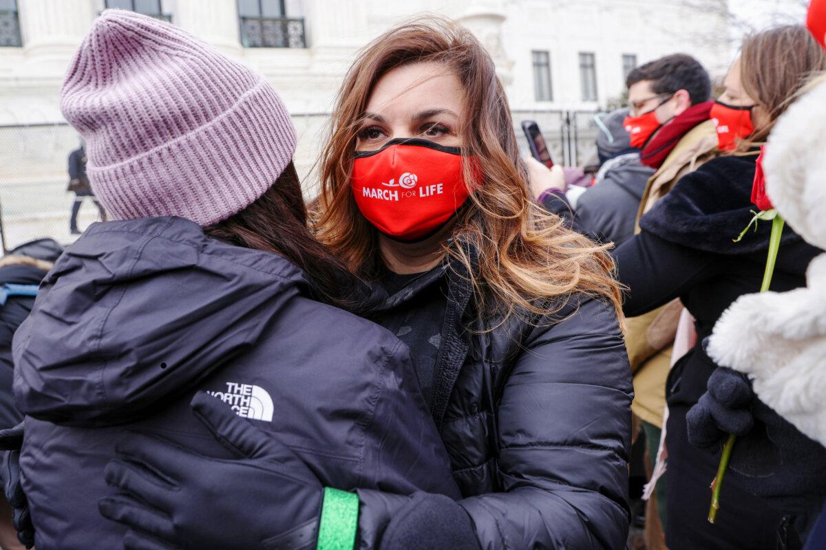 Abby Johnson, CEO of anti-abortion group And Then There Were None, hugs another pro-life activist outside the U.S. Supreme Court during the 48th annual March for Life in Washington on Jan. 29, 2021. (Alex Wong/Getty Images)