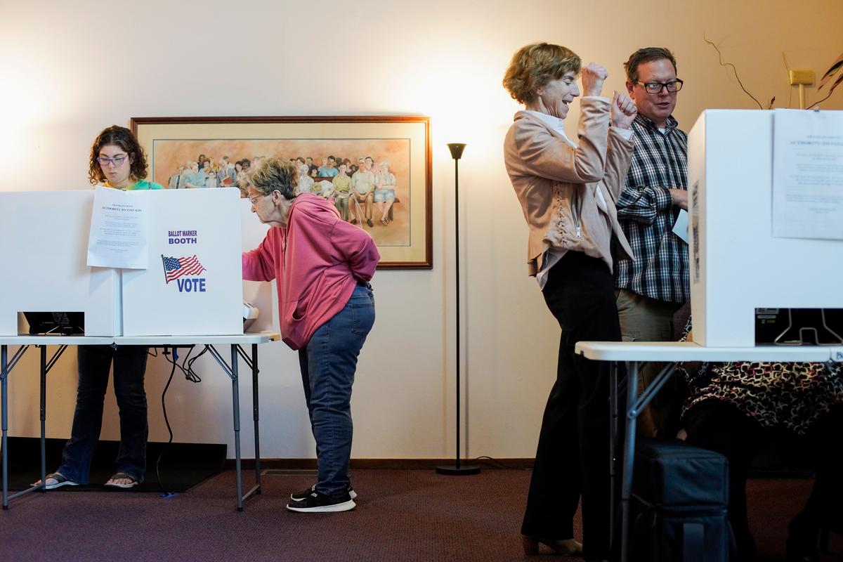 A poll worker helps a voter with a question at a polling location in Columbus, Ohio, on Nov. 7, 2023. (Andrew Spear/Getty Images)