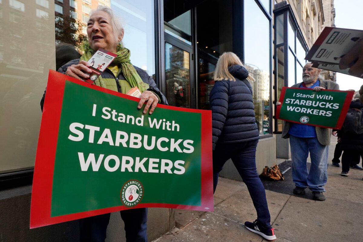Arlene Geiger (L) holds a sign supporting Starbucks workers outside a Starbucks on New York's Upper West Side on Nov. 16, 2023. (Richard Drew/AP Photo)
