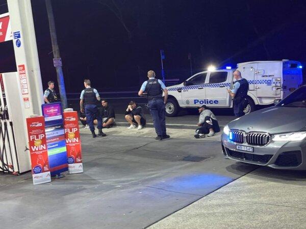 Police are seen talking to teenagers at a service station in an image shared by the Australian Jewish Association (credit: AJA)