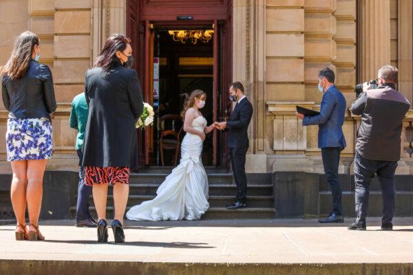 A wedding is held outside the registry office in Melbourne, Australia, on Oct. 26, 2020. (Asanka Ratnayake/Getty Images)