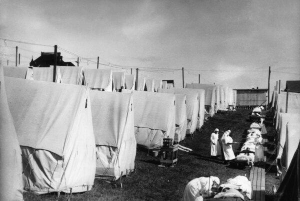 Spanish Flu 1918: Nurses care for victims of a Spanish influenza epidemic outdoors amidst canvas tents during an outdoor fresh air cure, Lawrence, Massachusetts. (Hulton Archive/Getty Images)