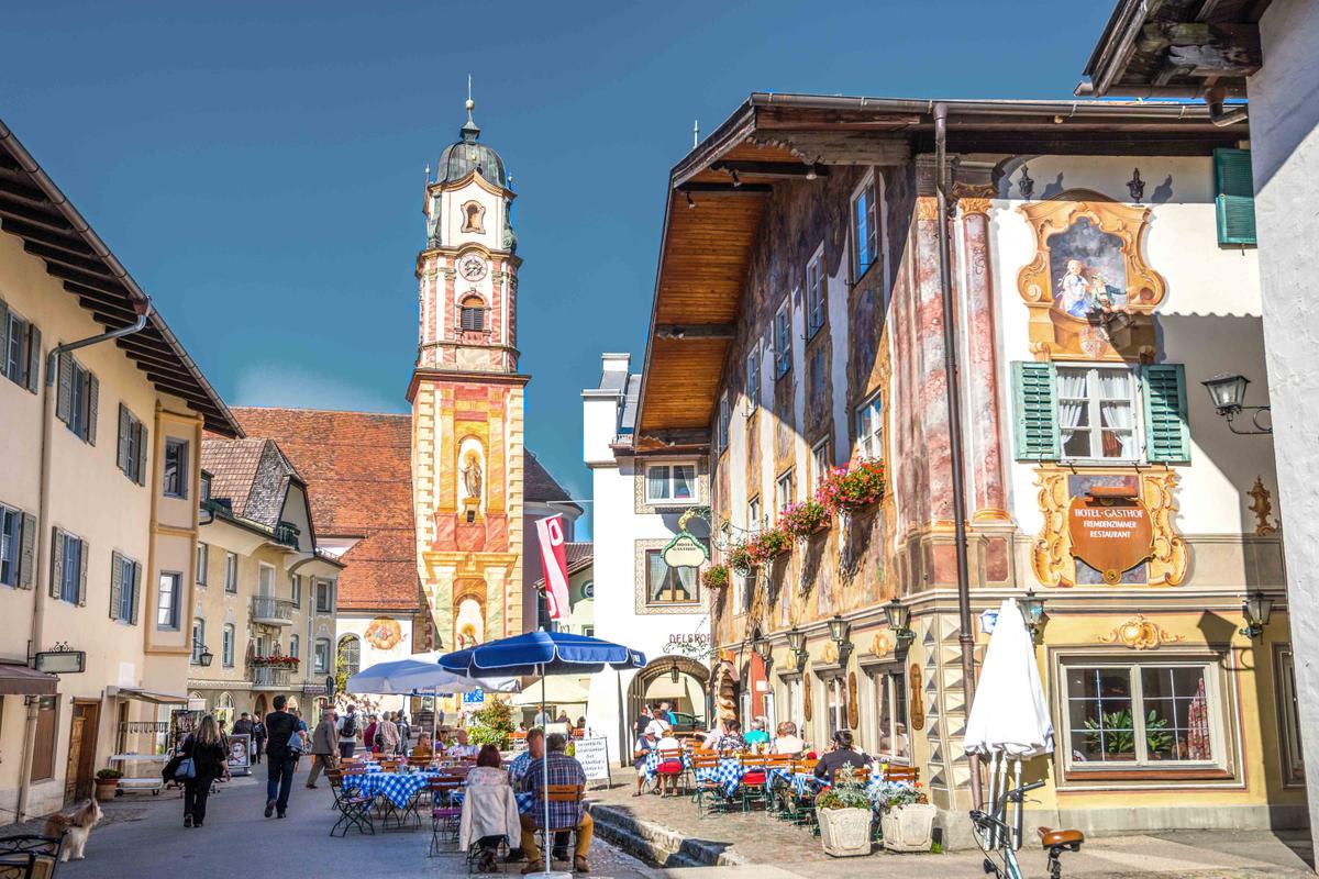 Marketgoers enjoy a beautiful day at the Obermarkt in Mittenwald, Germany. (Sina Ettmer Photography/Shutterstock)