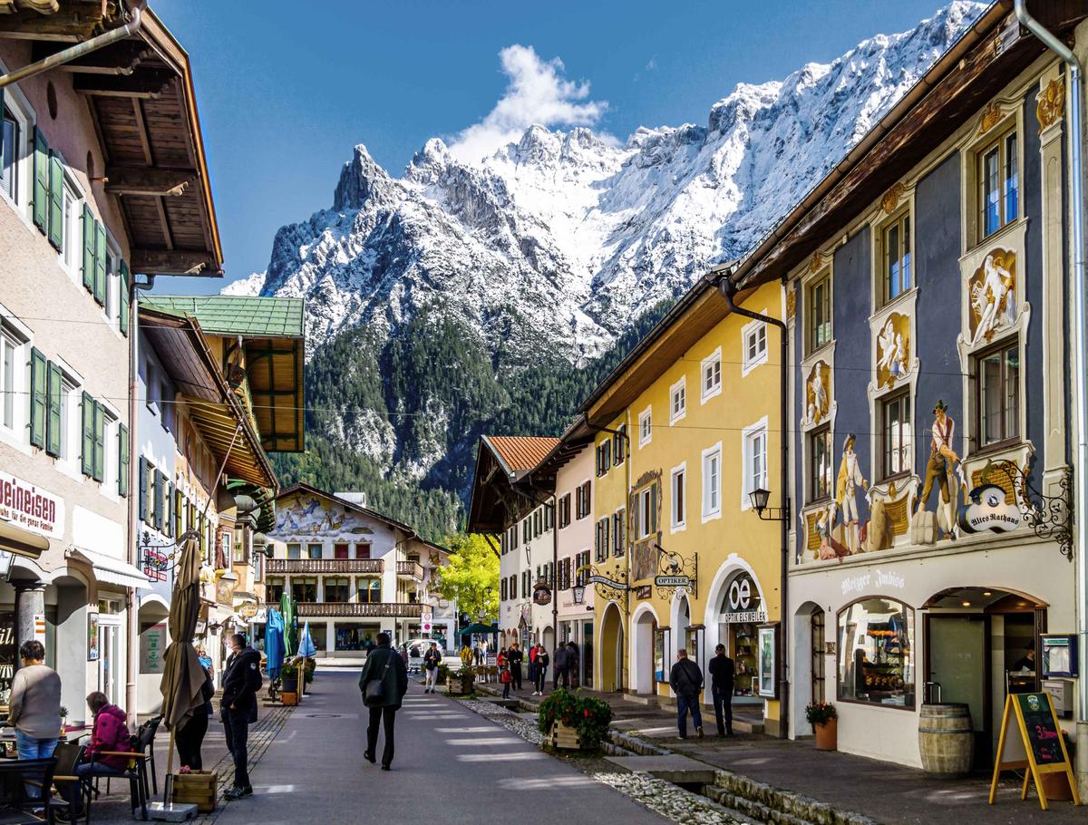 A small stream runs between fresco-decorated street fronts in Mittenwald, Germany. (FooTToo/Shutterstock)