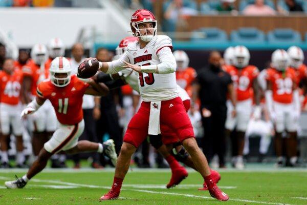Jack Plummer (13) of the Louisville Cardinals throws a pass against the Miami Hurricanes during the second quarter of the game in Miami Gardens, Fla., on Nov. 18, 2023. (Megan Briggs/Getty Images)