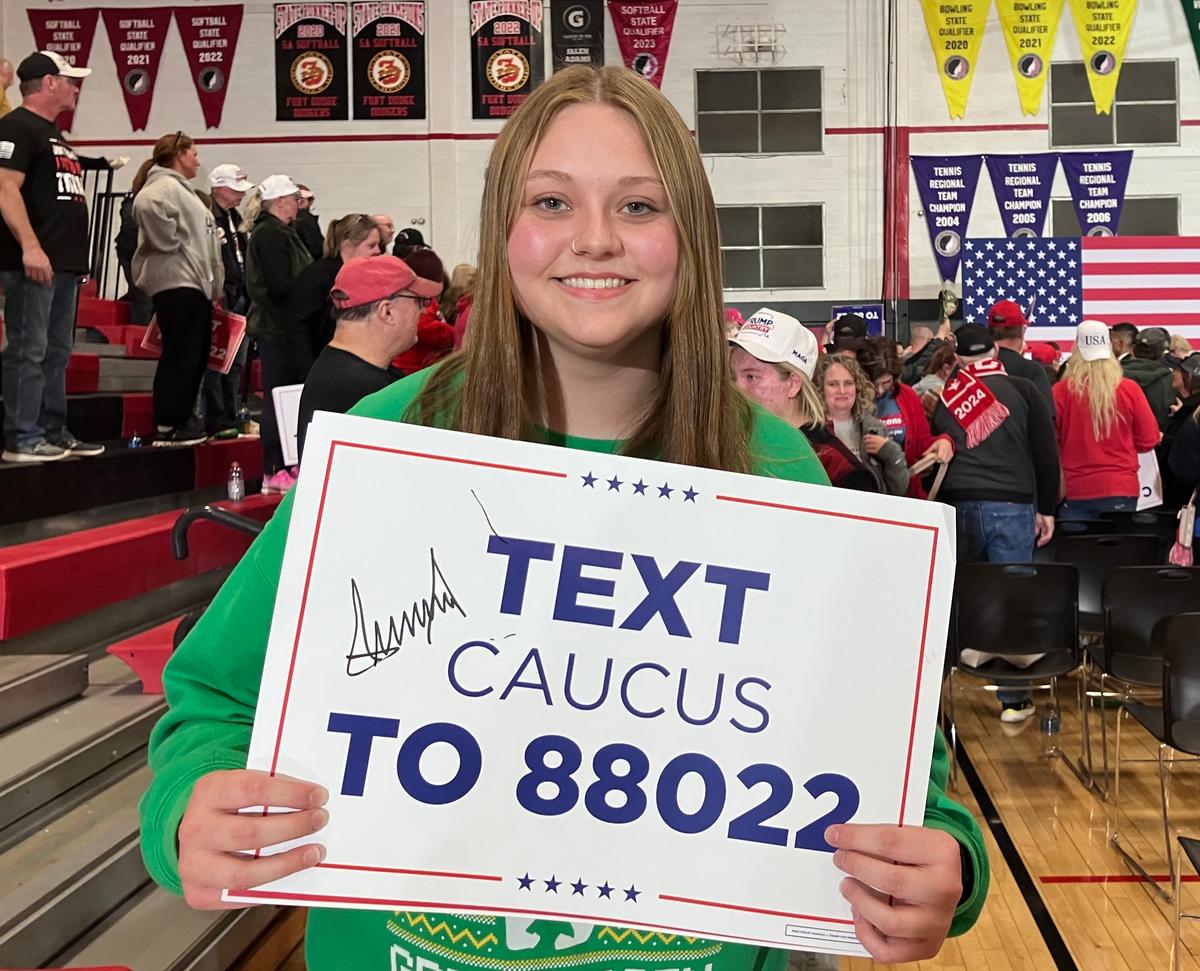 Justine Olson, 17, of Thor, Iowa, holds a placard that former President Donald Trump autographed after a rally at Fort Dodge Senior High School in Fort Dodge, Iowa, on Nov. 18, 2023. (Janice Hisle/The Epoch Times)