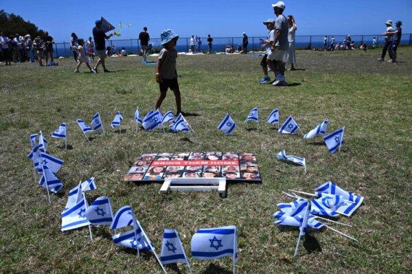 Israeli flags surround a placard as members of the Australian Jewish community hold a kite flying event for Israeli hostages who are currently being held by the Palestinian group Hamas, at a park in Sydney on Nov. 19, 2023. (Saeed Khan/AFP via Getty Images)